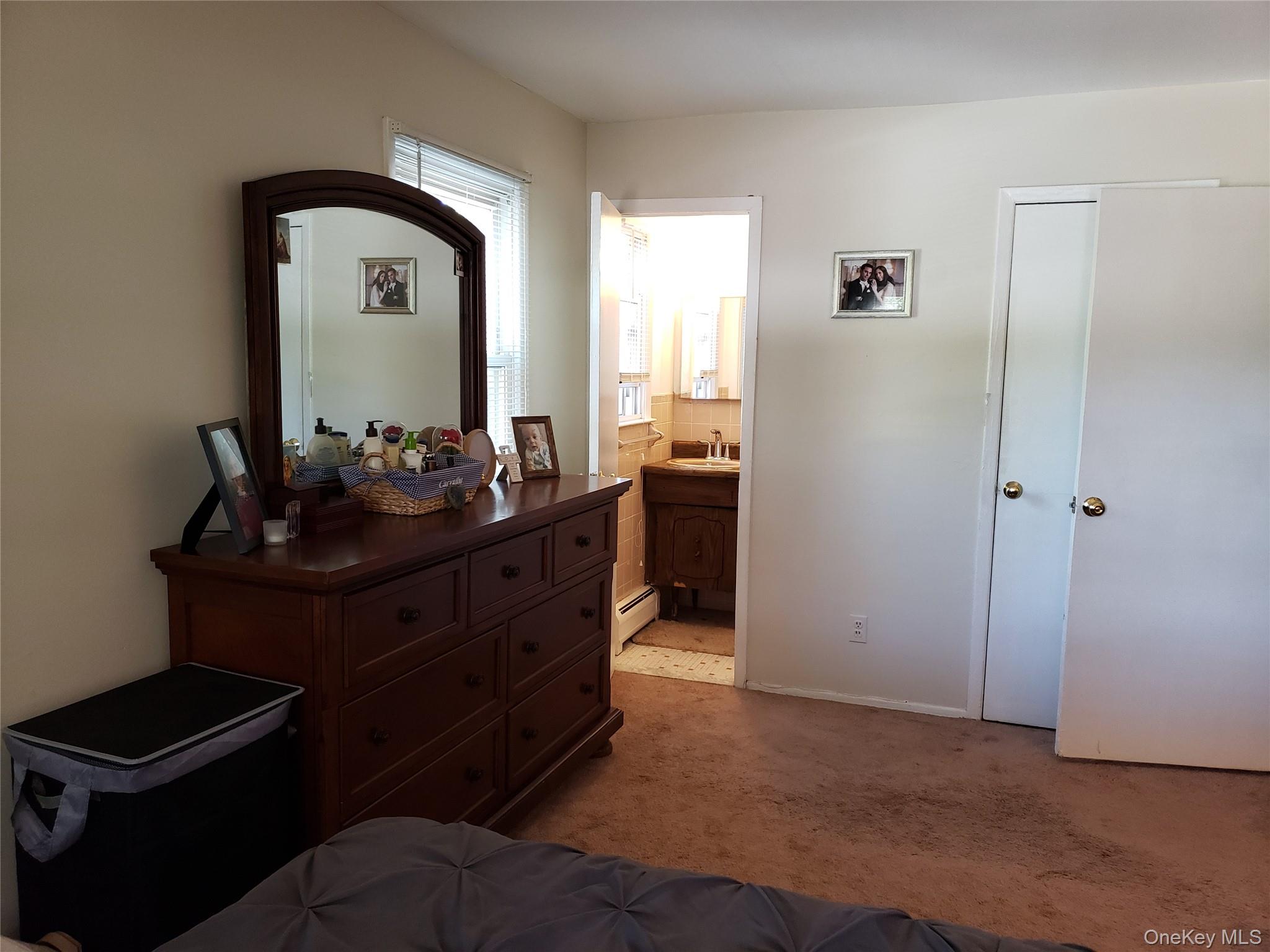 16-74 Bell Boulevard Queens, NY 11360 - Photo 14 of 20 Bedroom with carpet floors, ensuite bathroom, and a baseboard heating unit