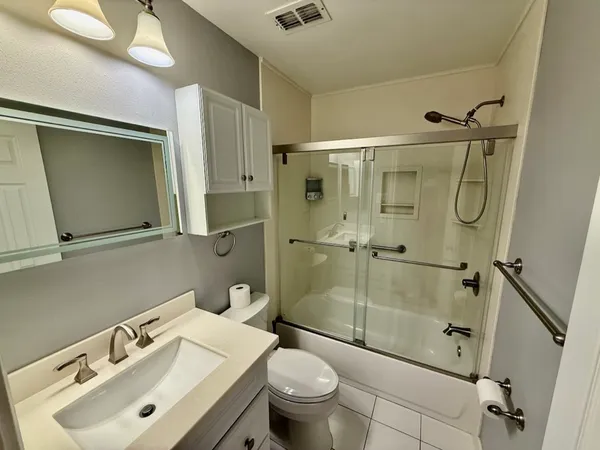 a bathroom with a sink toilet and shower