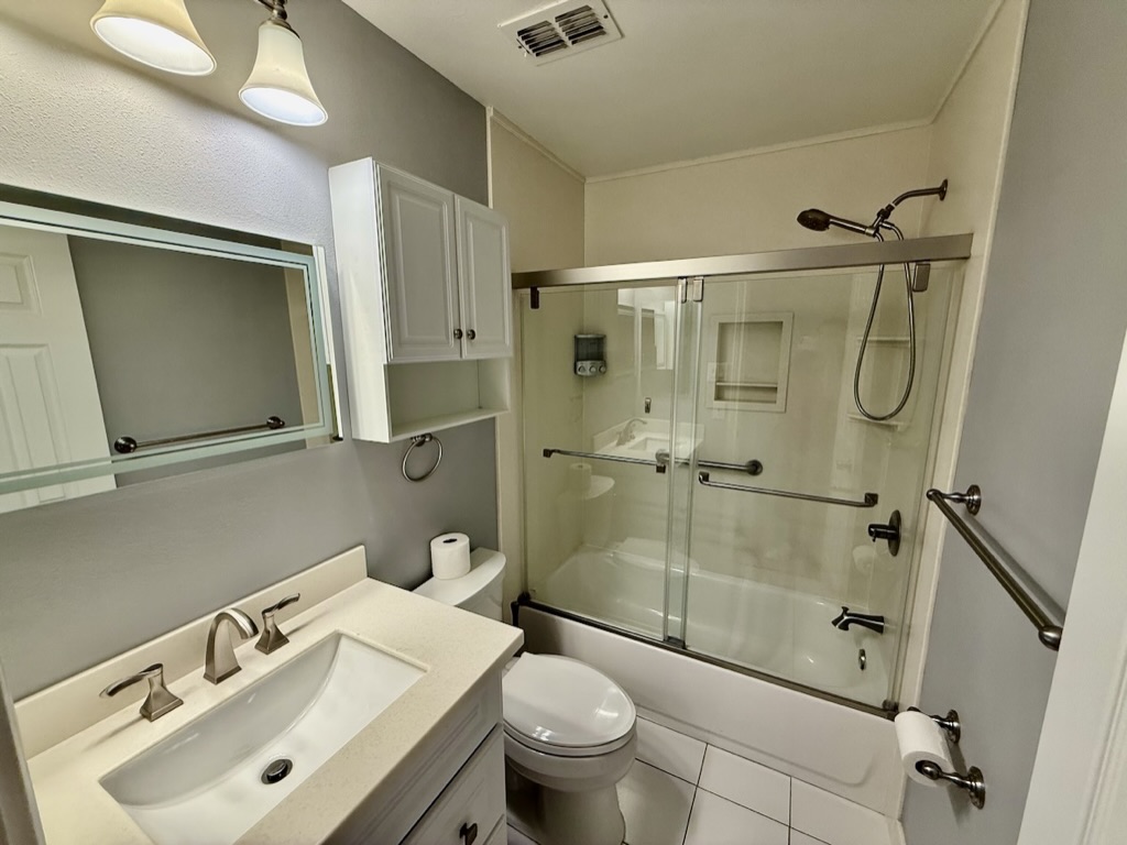 604 Cactus Bend Drive Pflugerville, TX 78660 - Photo 21 of 29 Full bath with visible vents, toilet, shower / bath combination with glass door, tile patterned flooring, and vanity