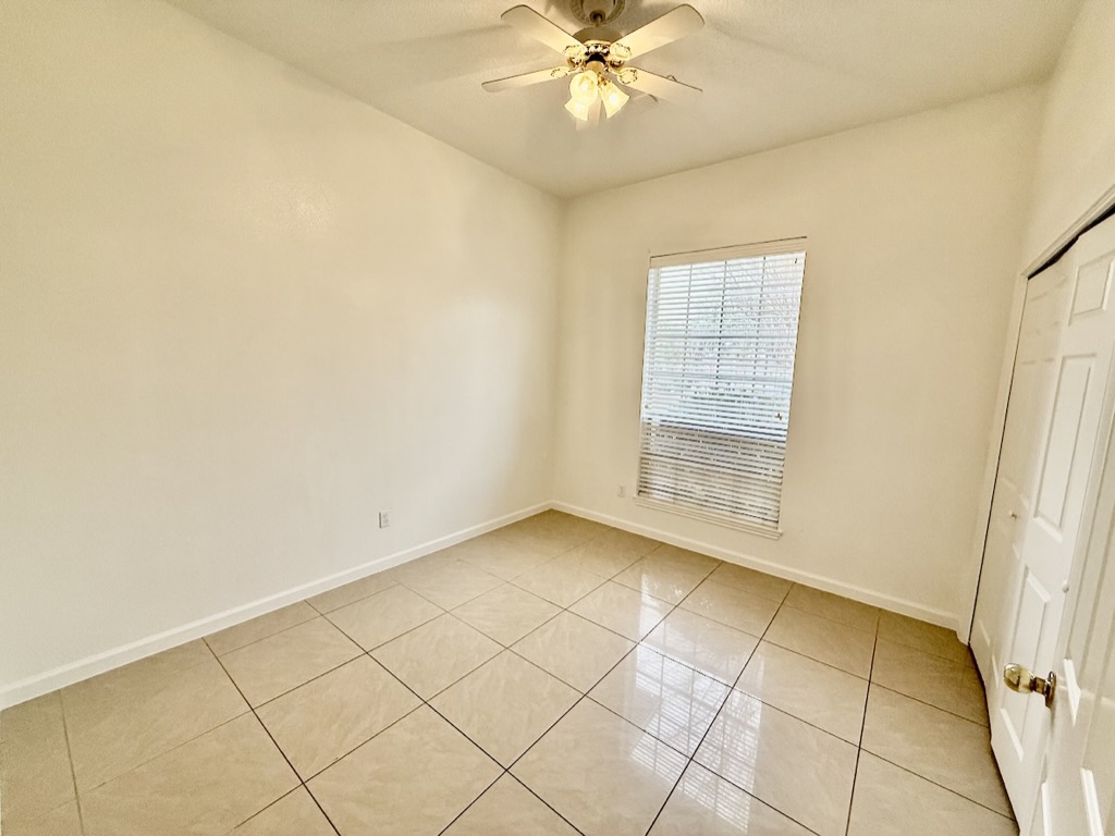 604 Cactus Bend Drive Pflugerville, TX 78660 - Photo 22 of 29 Empty room with baseboards, a ceiling fan, and light tile patterned flooring