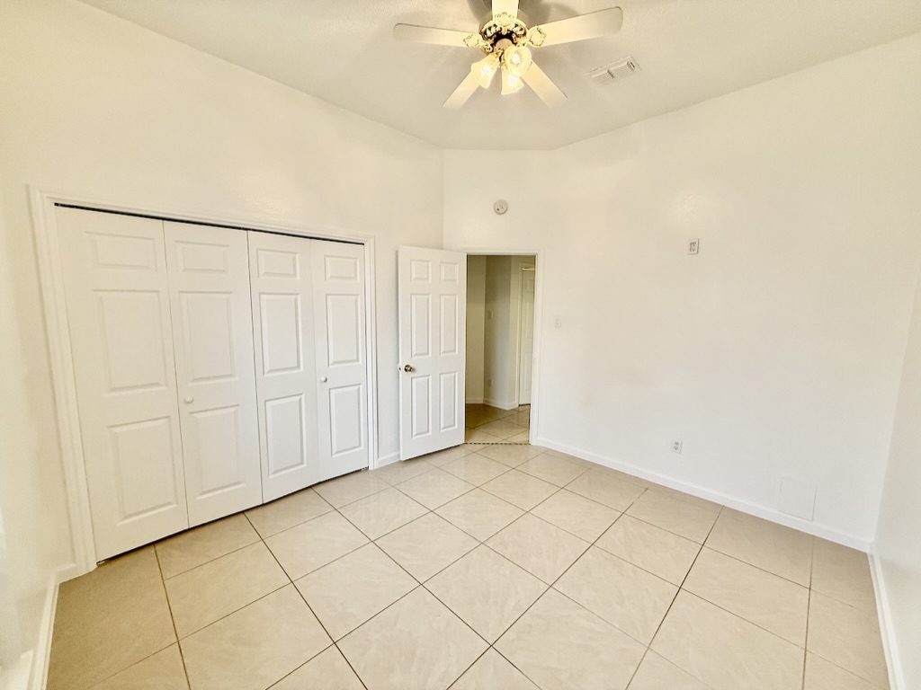 604 Cactus Bend Drive Pflugerville, TX 78660 - Photo 23 of 29 Unfurnished bedroom featuring a closet, light tile patterned flooring, visible vents, and baseboards