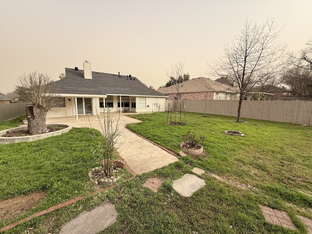 604 Cactus Bend Drive Pflugerville, TX 78660 - Photo 26 of 29 View of yard featuring a patio area and a fenced backyard