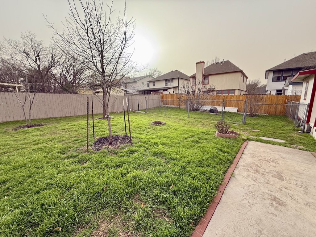 604 Cactus Bend Drive Pflugerville, TX 78660 - Photo 28 of 29 View of yard featuring a residential view and a fenced backyard