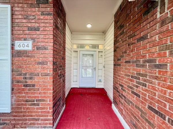 a view of a hallway with brick walls