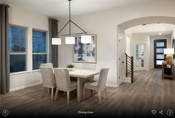 a dining room with furniture and wooden floor