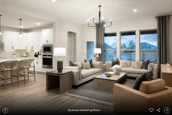 a living room with fireplace furniture and a large window