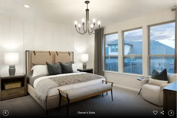 a bedroom with bed and a chandelier