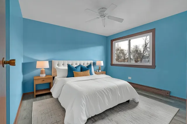 a bedroom with a large bed and a chandelier