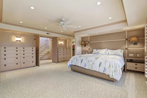 a spacious bedroom with a large bed and a walk in closet