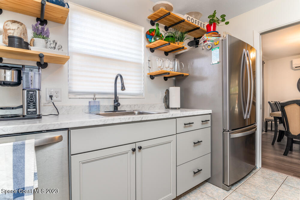 2449 Apache Drive Melbourne, FL 32935 - Photo 44 of 61 a kitchen with cabinets a sink and refrigerator
