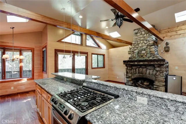 a kitchen with stainless steel appliances granite countertop a stove and a wooden cabinets