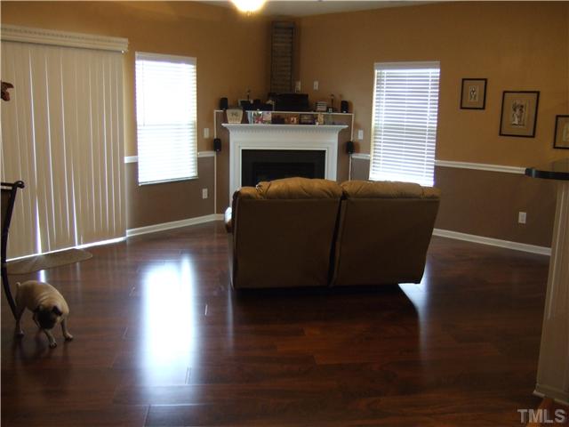 3218 Dove Tree Lane Raleigh, NC 27610 - Photo 2 of 15 a living room with wooden floors and a fireplace
