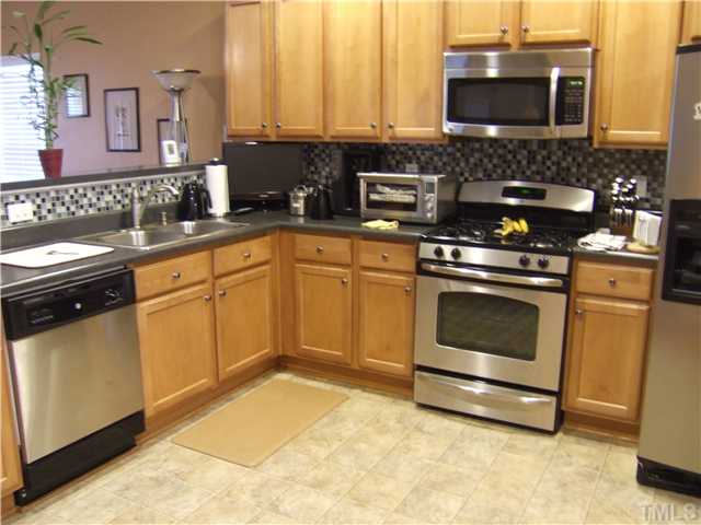 3218 Dove Tree Lane Raleigh, NC 27610 - Photo 4 of 15 a kitchen with stainless steel appliances granite countertop a stove a sink and a microwave