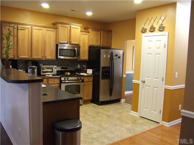 3218 Dove Tree Lane Raleigh, NC 27610 - Photo 5 of 15 a kitchen with a refrigerator and a sink