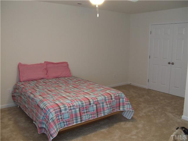 3218 Dove Tree Lane Raleigh, NC 27610 - Photo 10 of 15 a bedroom with a bed and window