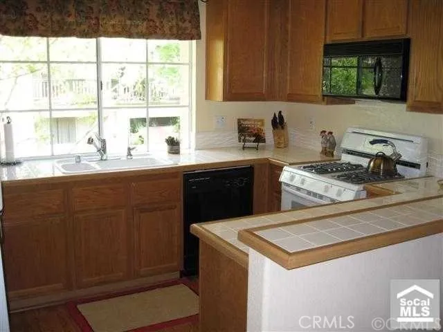 a kitchen with a sink window and cabinets