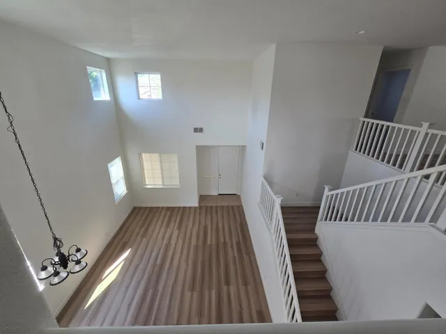a view of a livingroom with an empty space window and wooden floor