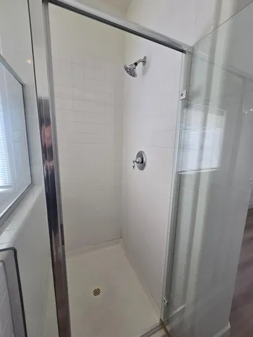 a view of a room with wooden floor and a window