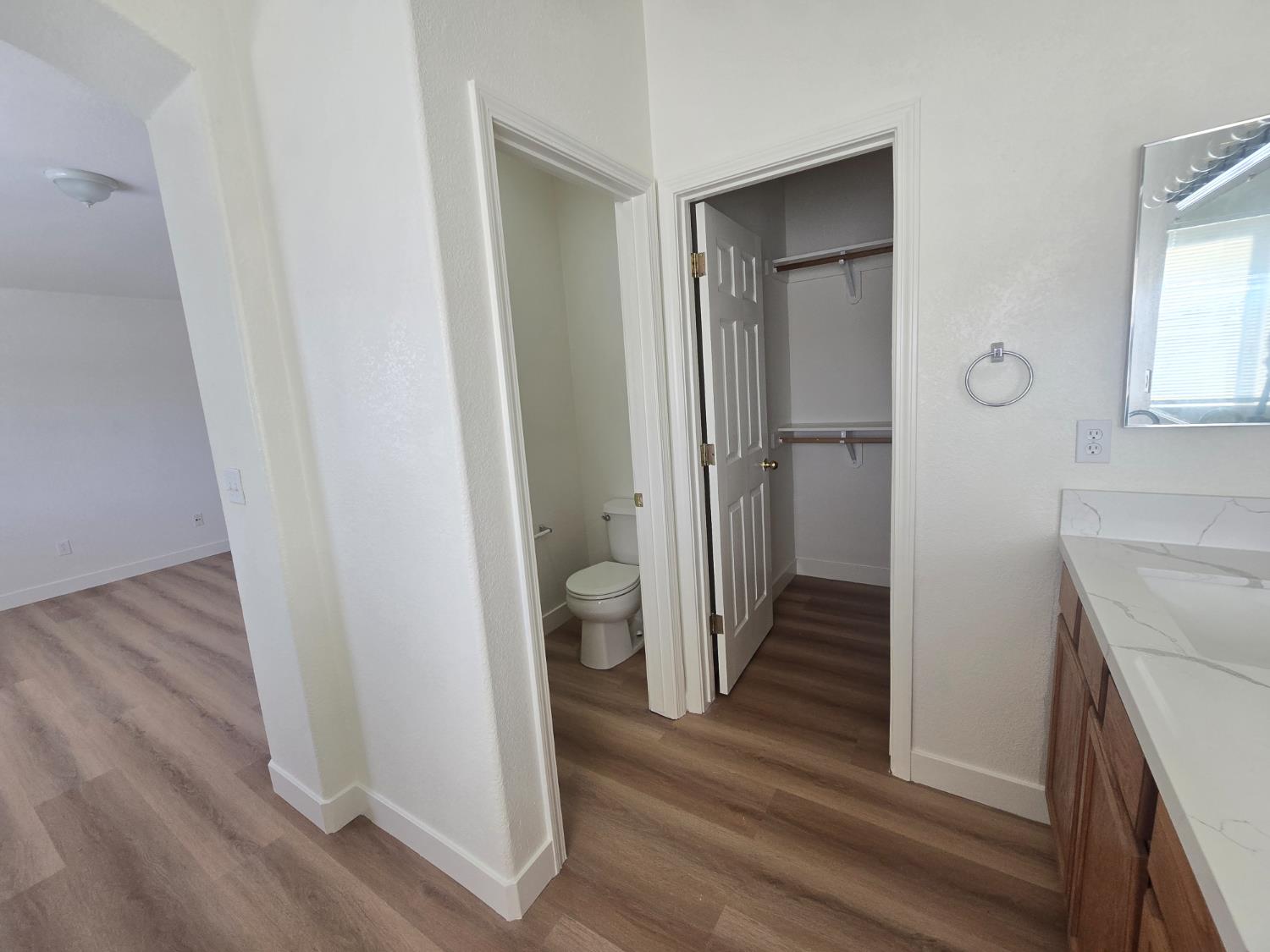 10554 Rudder Way Stockton, CA 95209 - Photo 18 of 40 a view of a hallway with wooden floor and a livingroom