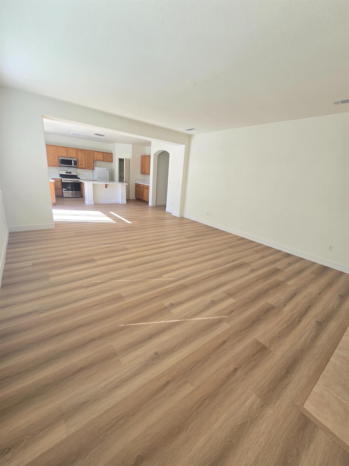 10554 Rudder Way Stockton, CA 95209 - Photo 24 of 40 a view of a room with wooden floor and a window