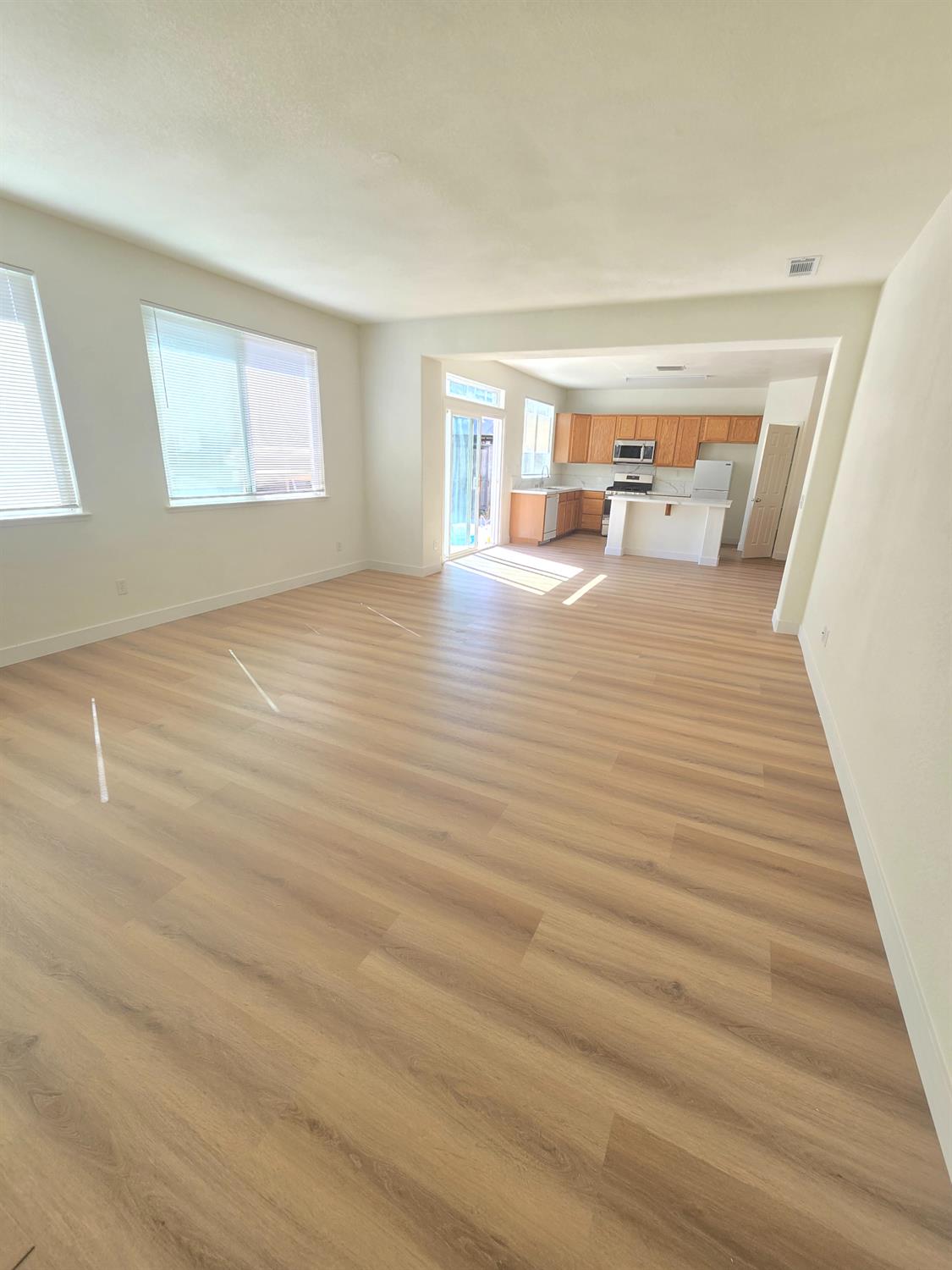 10554 Rudder Way Stockton, CA 95209 - Photo 25 of 40 a view of a bedroom with wooden floor and windows