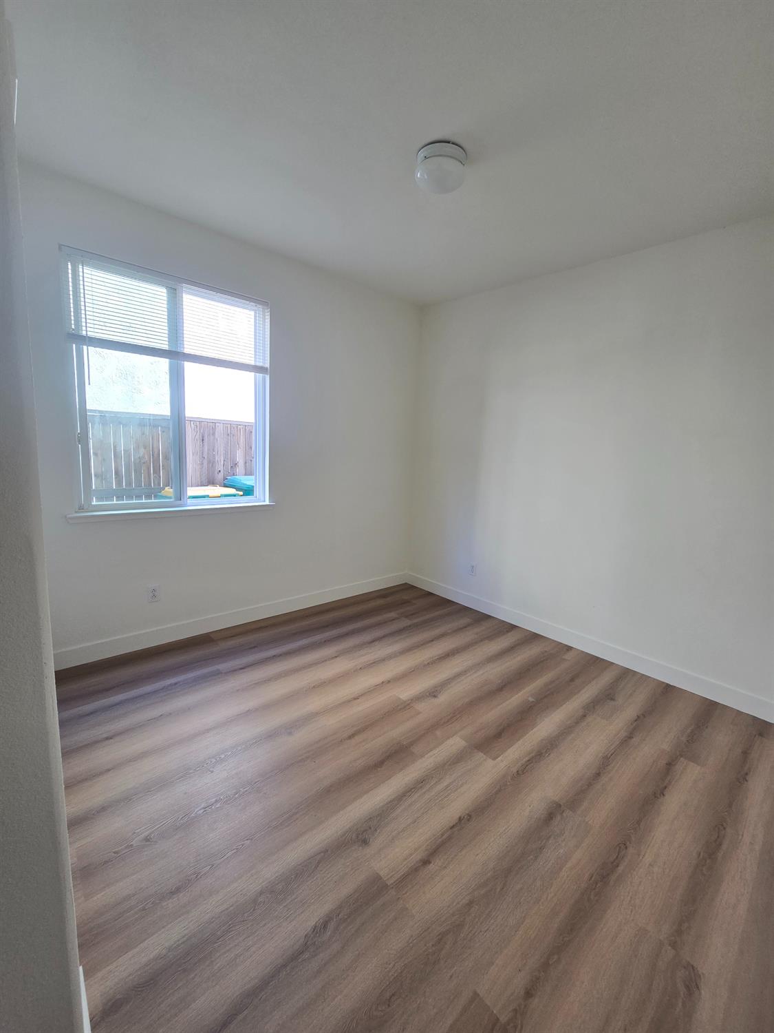 10554 Rudder Way Stockton, CA 95209 - Photo 34 of 40 a view of empty room with wooden floor and fan