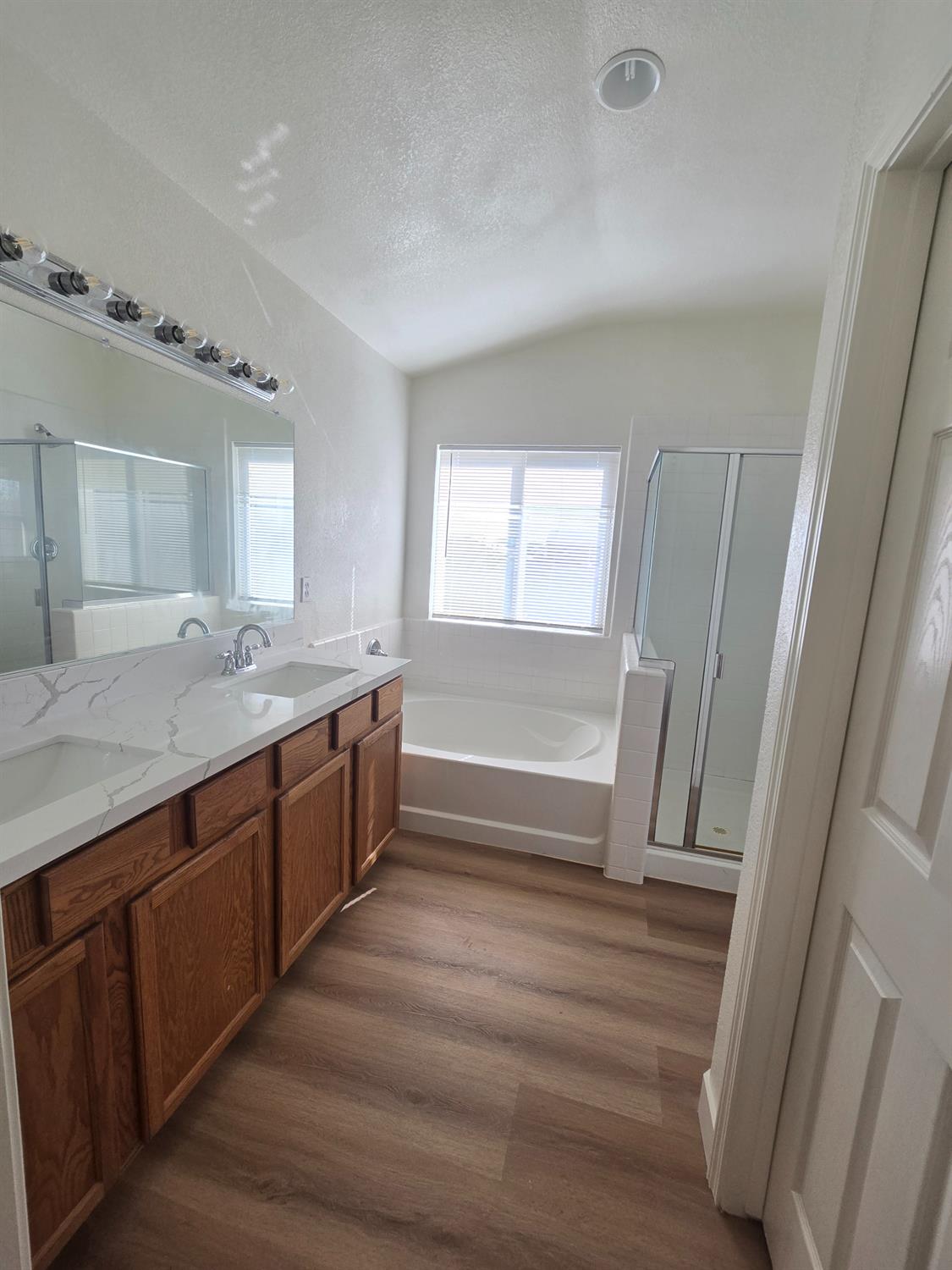 10554 Rudder Way Stockton, CA 95209 - Photo 9 of 40 a spacious bathroom with a double vanity sink a mirror and a shower