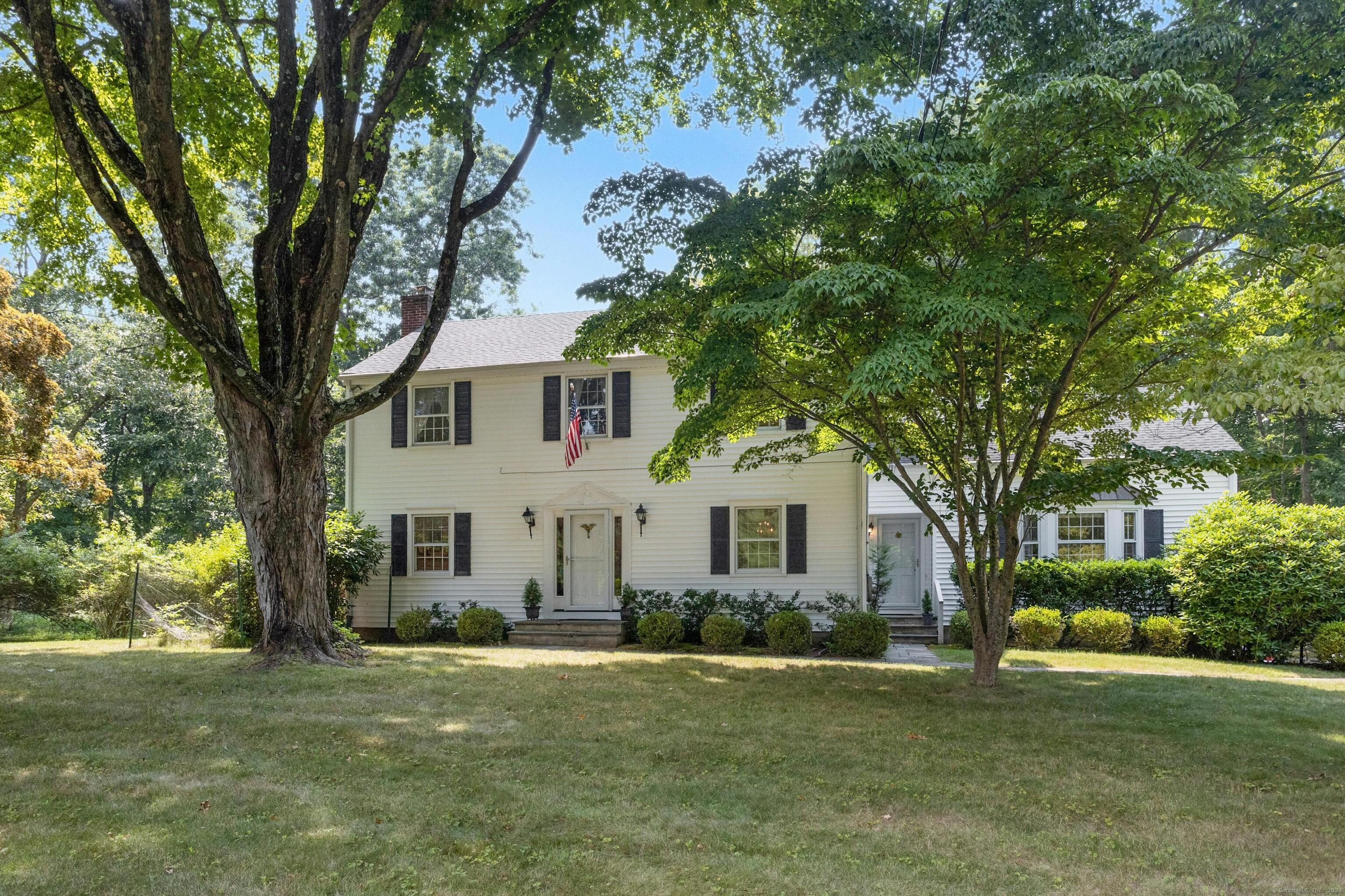 200 East Hunting Ridge Road Stamford, CT 06903 - Photo 1 of 1 a front view of a house with a garden and tree