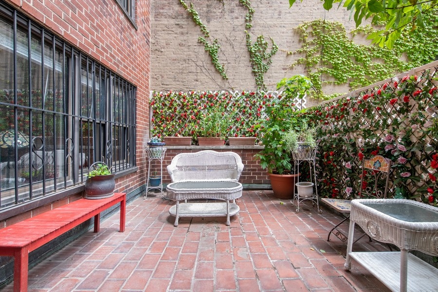 a view of a patio with a table and chairs and a potted plant
