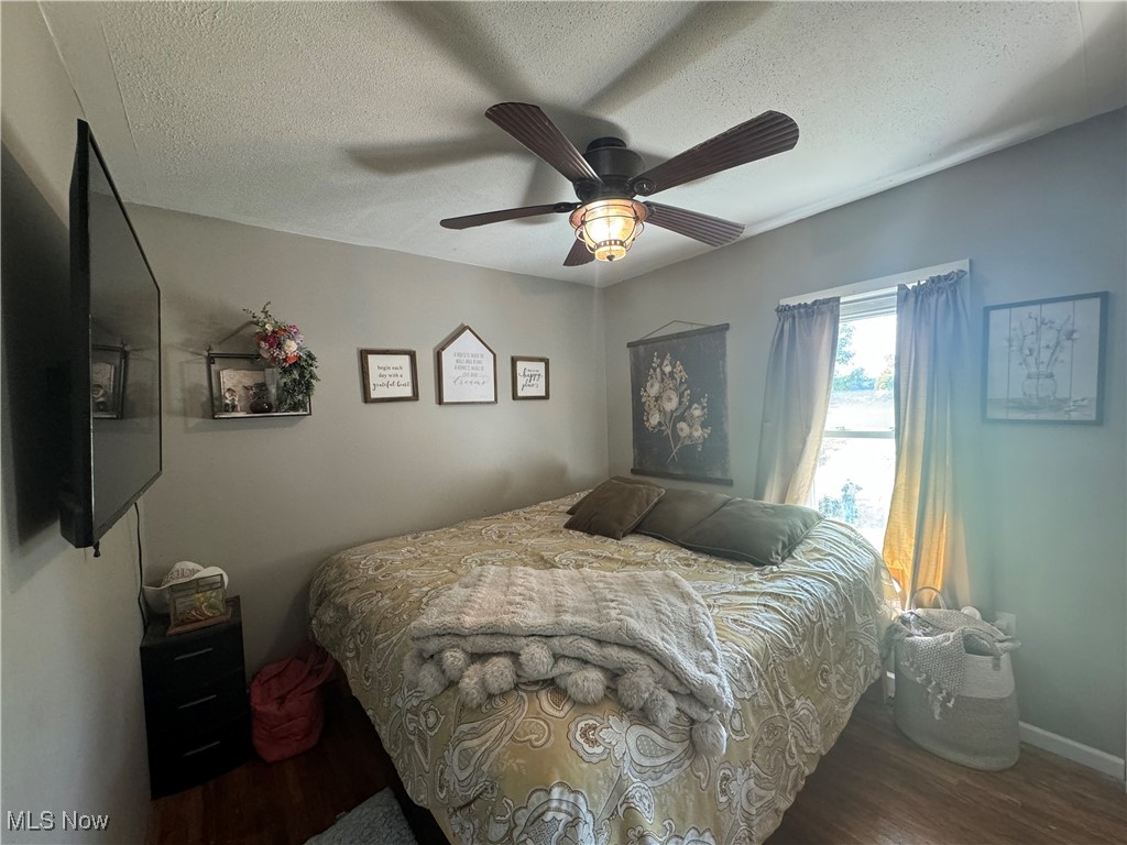 1480 Jerrys Run Road Belleville, WV 26133 - Photo 29 of 48 Bedroom featuring a textured ceiling, ceiling fan, and dark hardwood / wood-style flooring