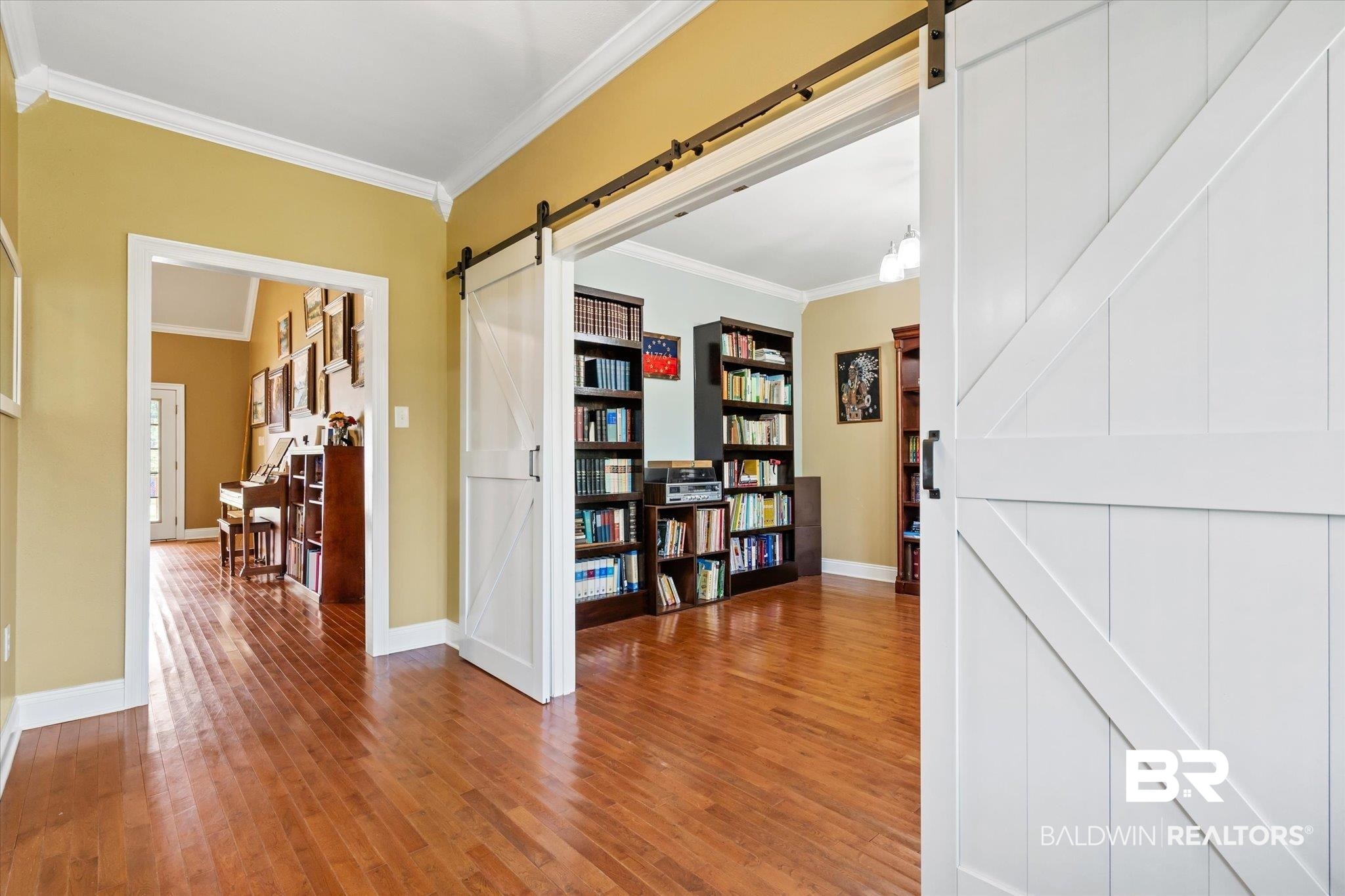 72 Limestone Drive Jackson, AL 36545 - Photo 11 of 38 Hall with crown molding, hardwood / wood-style floors, and a barn door