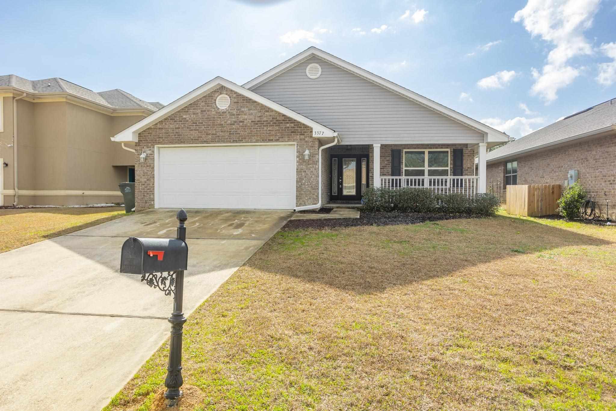 3377 Wasatch Range Loop Pensacola, FL 32526 - Photo 1 of 34 a front view of a house with a yard