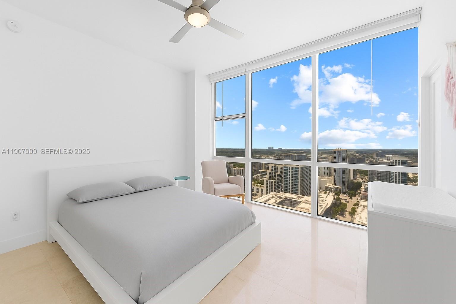 665 Northeast 25th Street, Unit PHI01 Miami, FL 33137 - Photo 24 of 38 a bedroom with a large bed and a large window with outer view