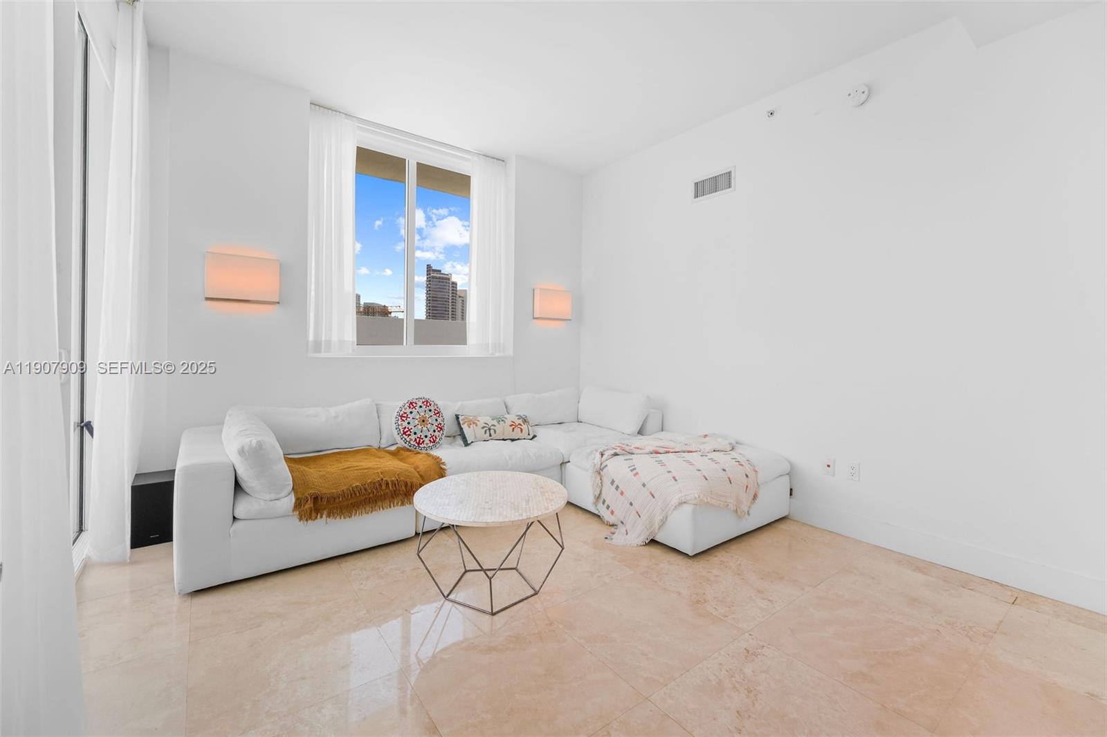 665 Northeast 25th Street, Unit PHI01 Miami, FL 33137 - Photo 32 of 38 a bedroom with bed and a couch