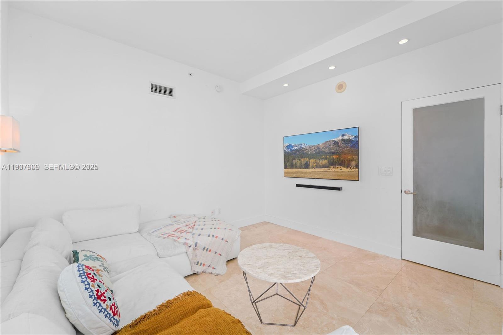 665 Northeast 25th Street, Unit PHI01 Miami, FL 33137 - Photo 34 of 38 a living room with furniture and a rug