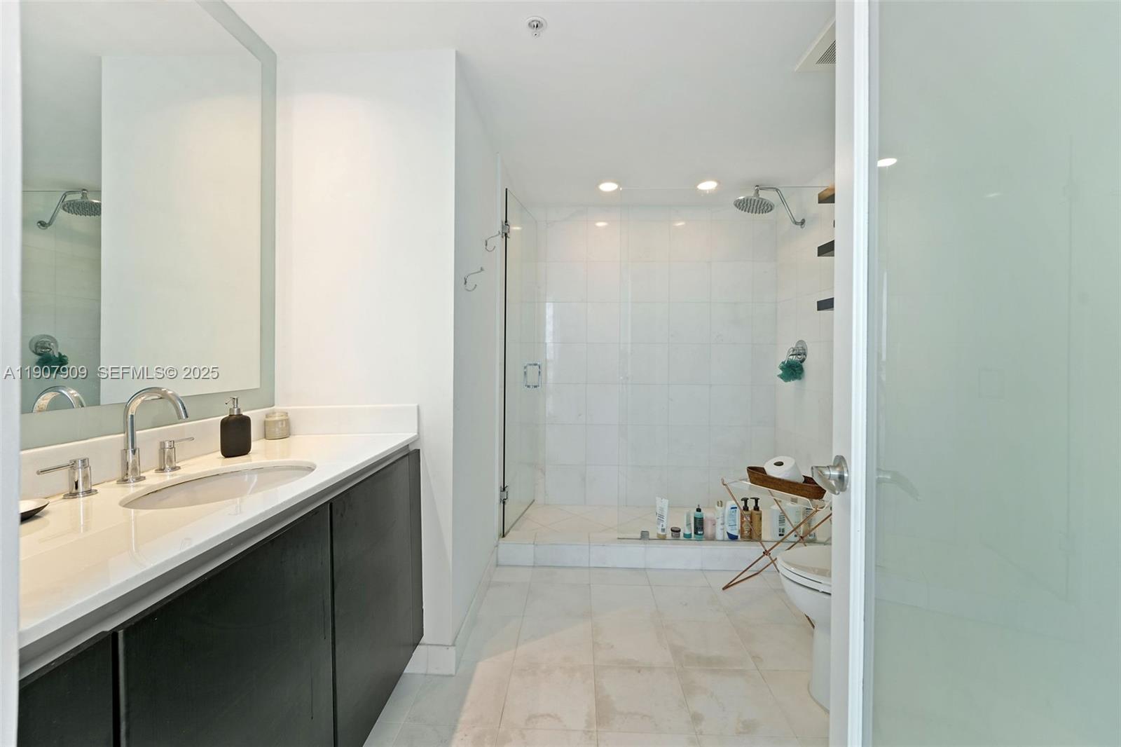 665 Northeast 25th Street, Unit PHI01 Miami, FL 33137 - Photo 36 of 38 a bathroom with a tub sink and mirror