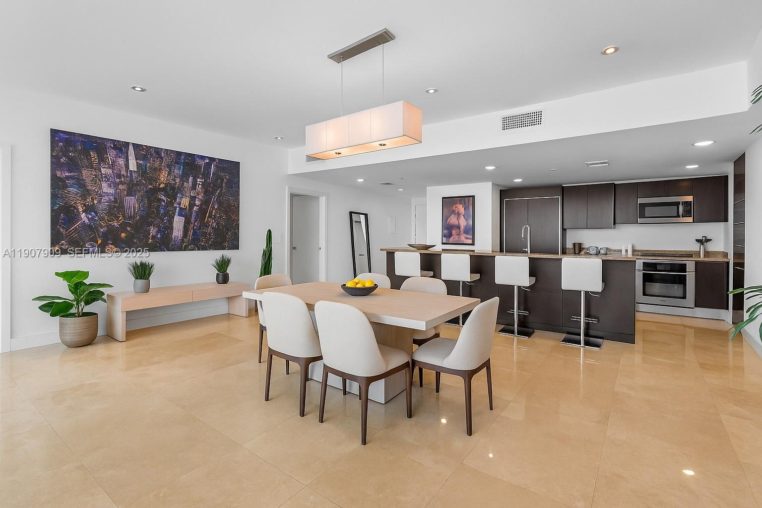 665 Northeast 25th Street, Unit PHI01 Miami, FL 33137 - Photo 10 of 38 a view of a dining room with furniture