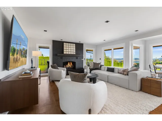 a living room with fireplace furniture and a flat screen tv
