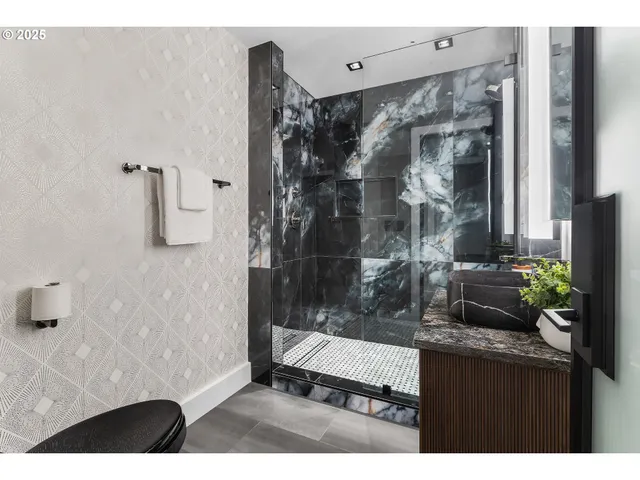 a bathroom with a glass shower door