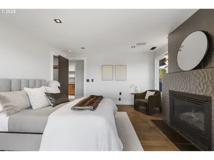 a bedroom with a bed a fireplace and a couch