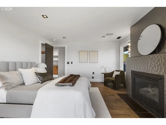 a bedroom with a bed a fireplace and a couch