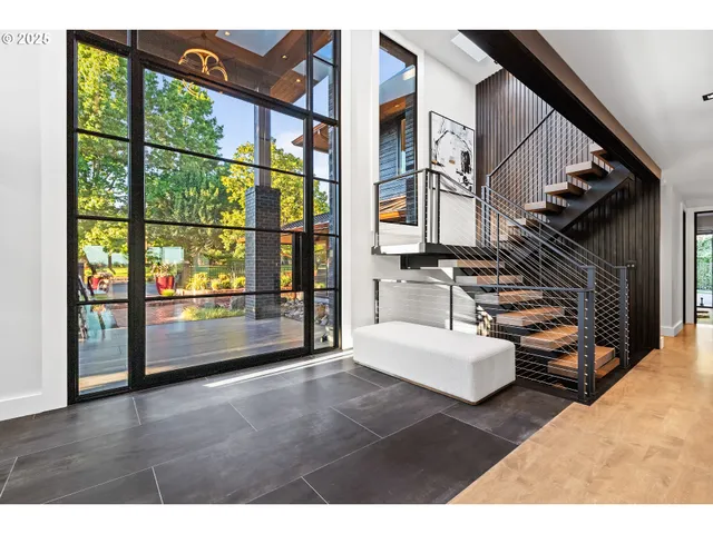 a living room with furniture and a floor to ceiling window