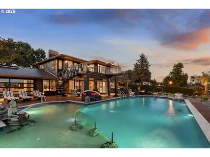 a view of a house with swimming pool and sitting area