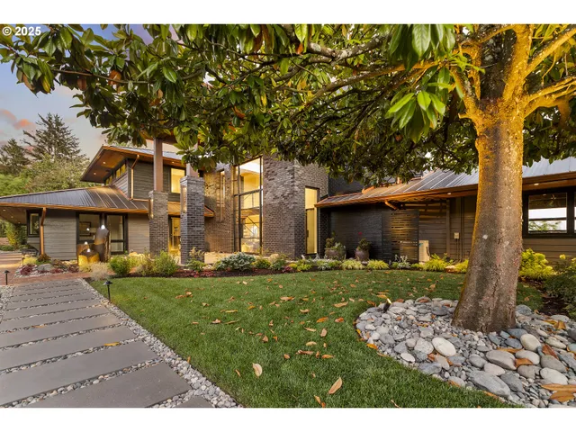 a backyard of a house with barbeque oven table and chairs
