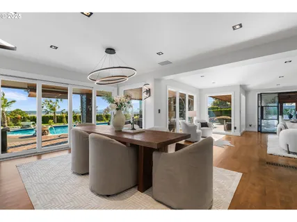 a living room with furniture a large window and a table