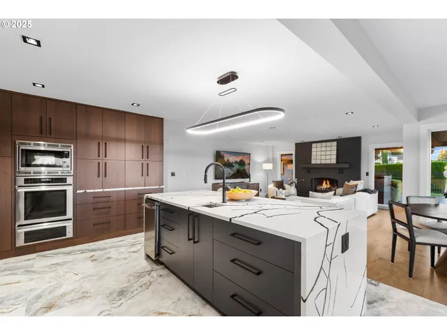 a kitchen with a sink a stove and cabinets