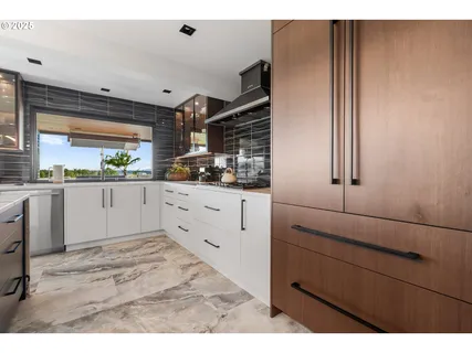 a kitchen with a sink window and cabinets