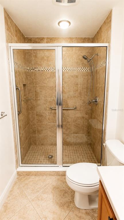 6552 Moorings Point Circle, Unit 102 Lakewood Ranch, FL 34202 - Photo 33 of 57 a bathroom with a shower and a toilet