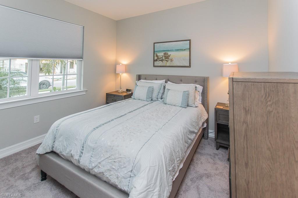 14670 Catamaran Place Naples, FL 34114 - Photo 14 of 24 a large bed sitting in a bedroom next to a window