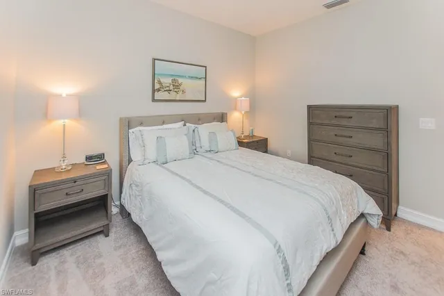 a bedroom with a bed and a dresser